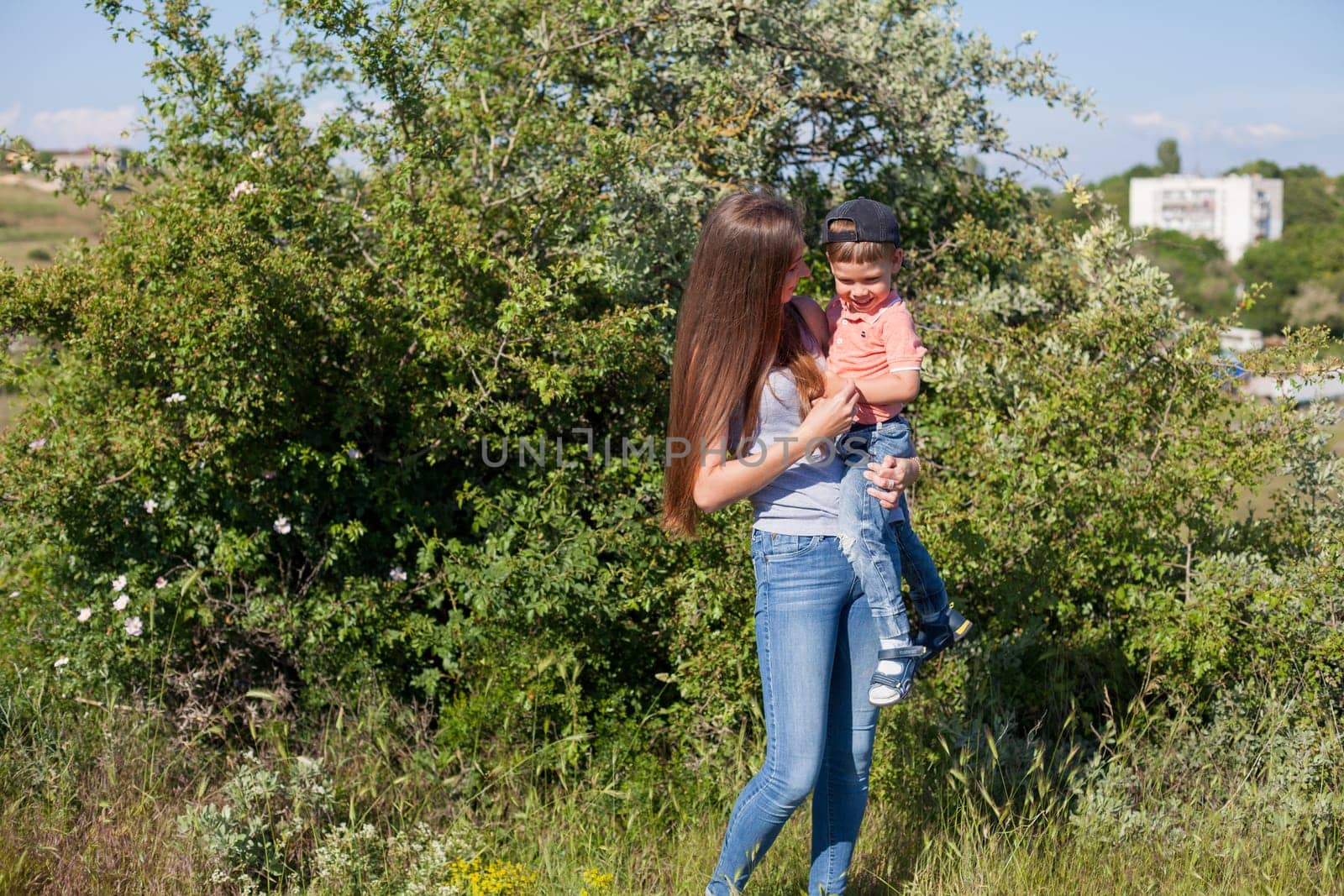 Mom and son play in the park on nature