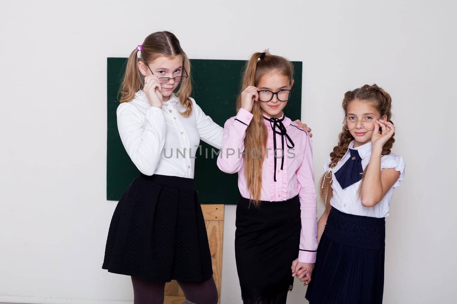 three girls at the board in class in class at school