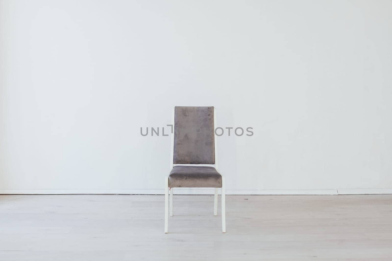 gray chair stands alone in the room