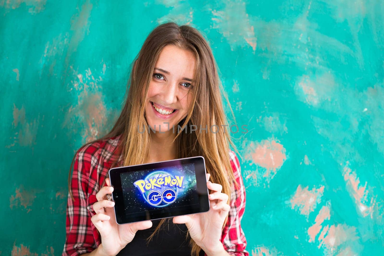 Ufa, Russia. - July 29: Woman show the tablet with Pokemon Go logo