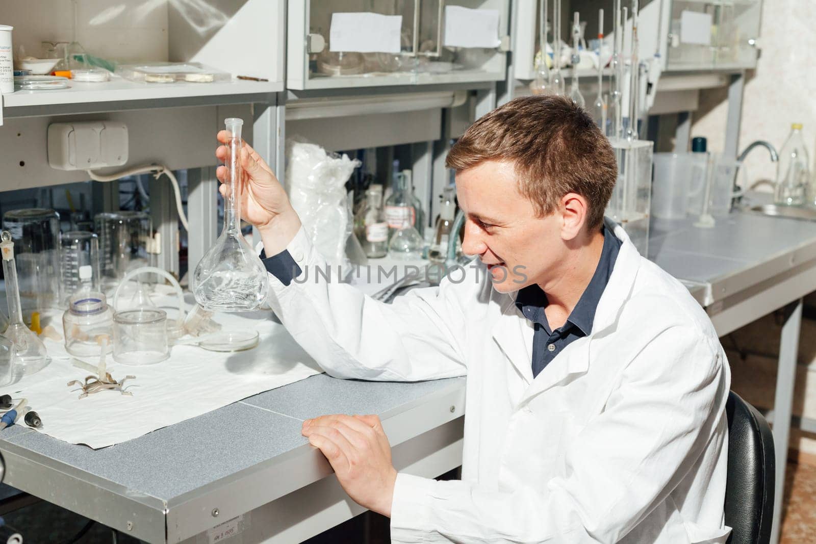 scientist conducts chemical experiments with liquids in the laboratory