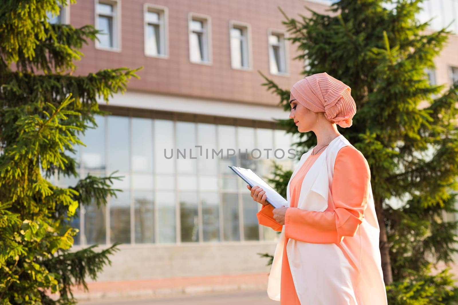 Muslim woman holding document paper by Satura86