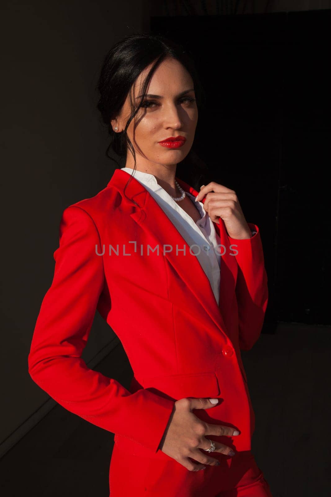 Portrait of a beautiful female student in a red business suit by Simakov