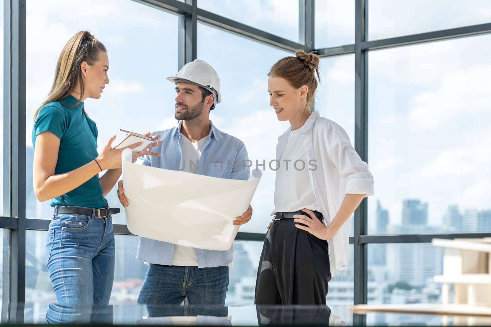 Group of architect engineer looking at project plan while brainstorming idea about building structure. Manager team discuss about building construction while standing near with city view. Tracery.