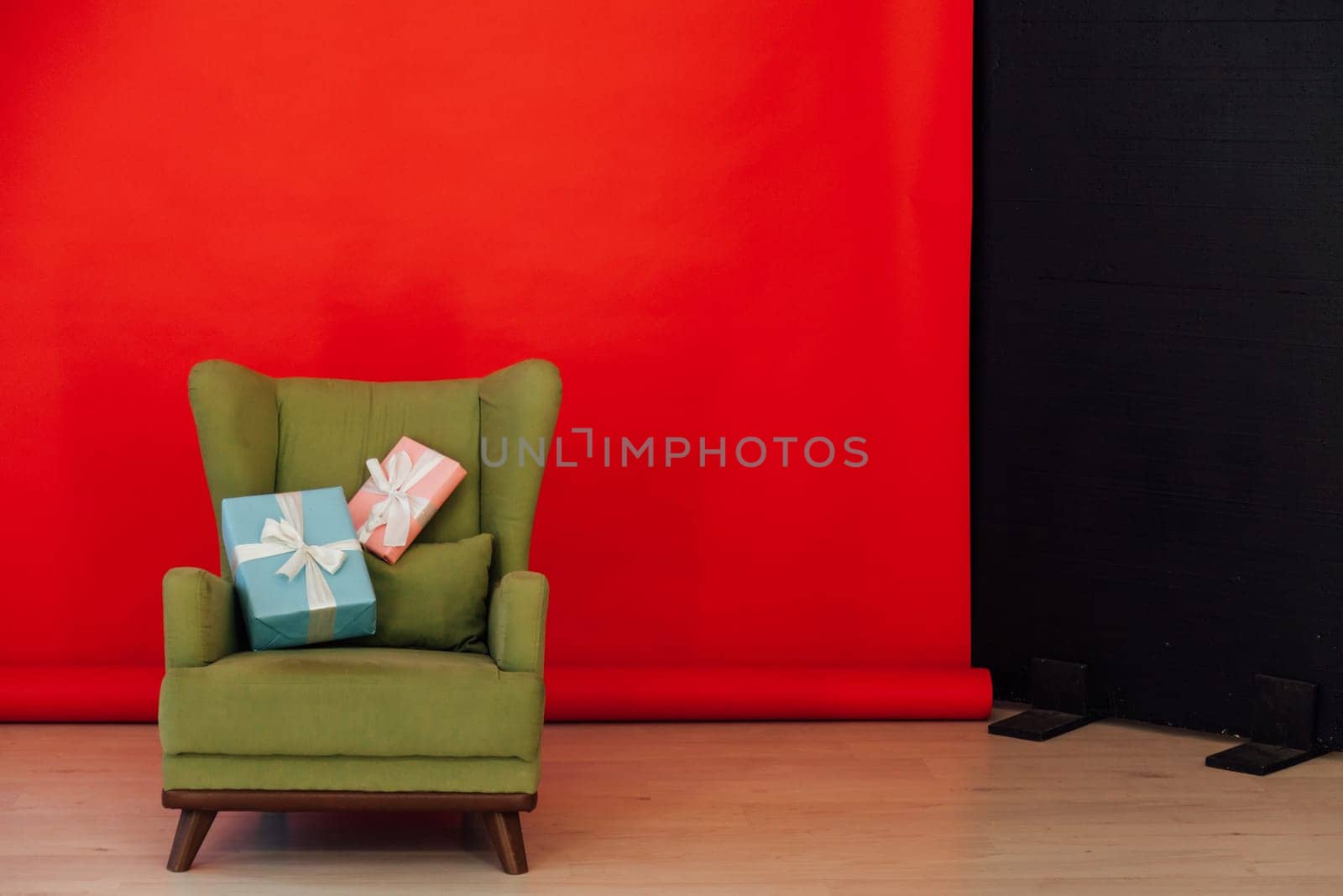Red black background chair with gifts for Christmas birthday party by Simakov