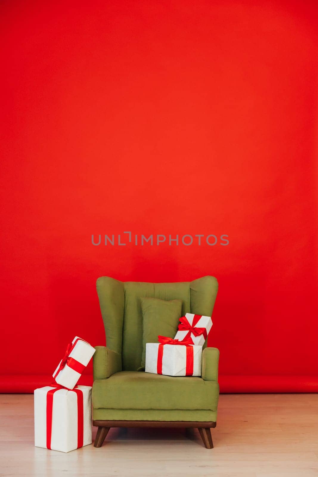 Red black background green chair with gifts for Christmas birthday party