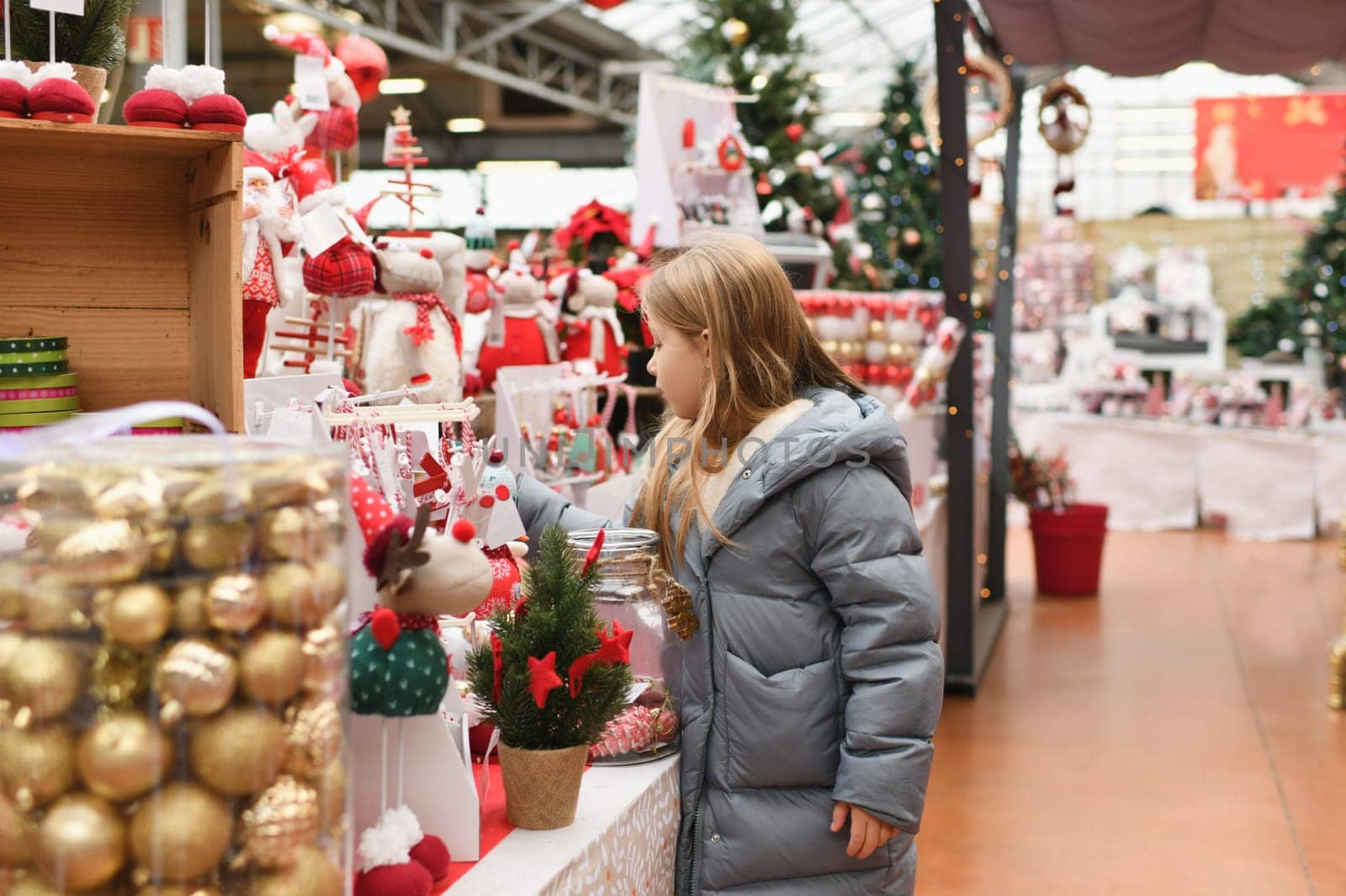 A girl choose the toys for the Christmas tree