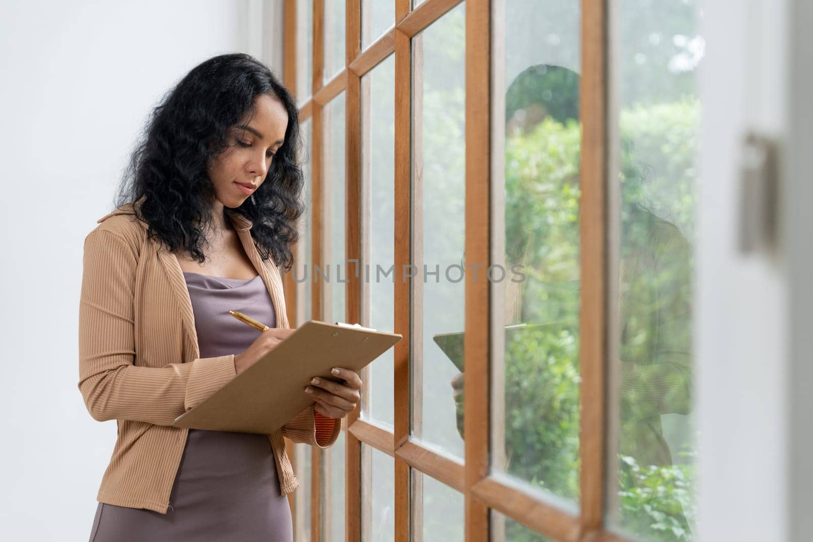 Psychologist woman in clinic office professional portrait with friendly smile feeling inviting for patient to visit the psychologist. The experienced and confident psychologist is crucial specialist