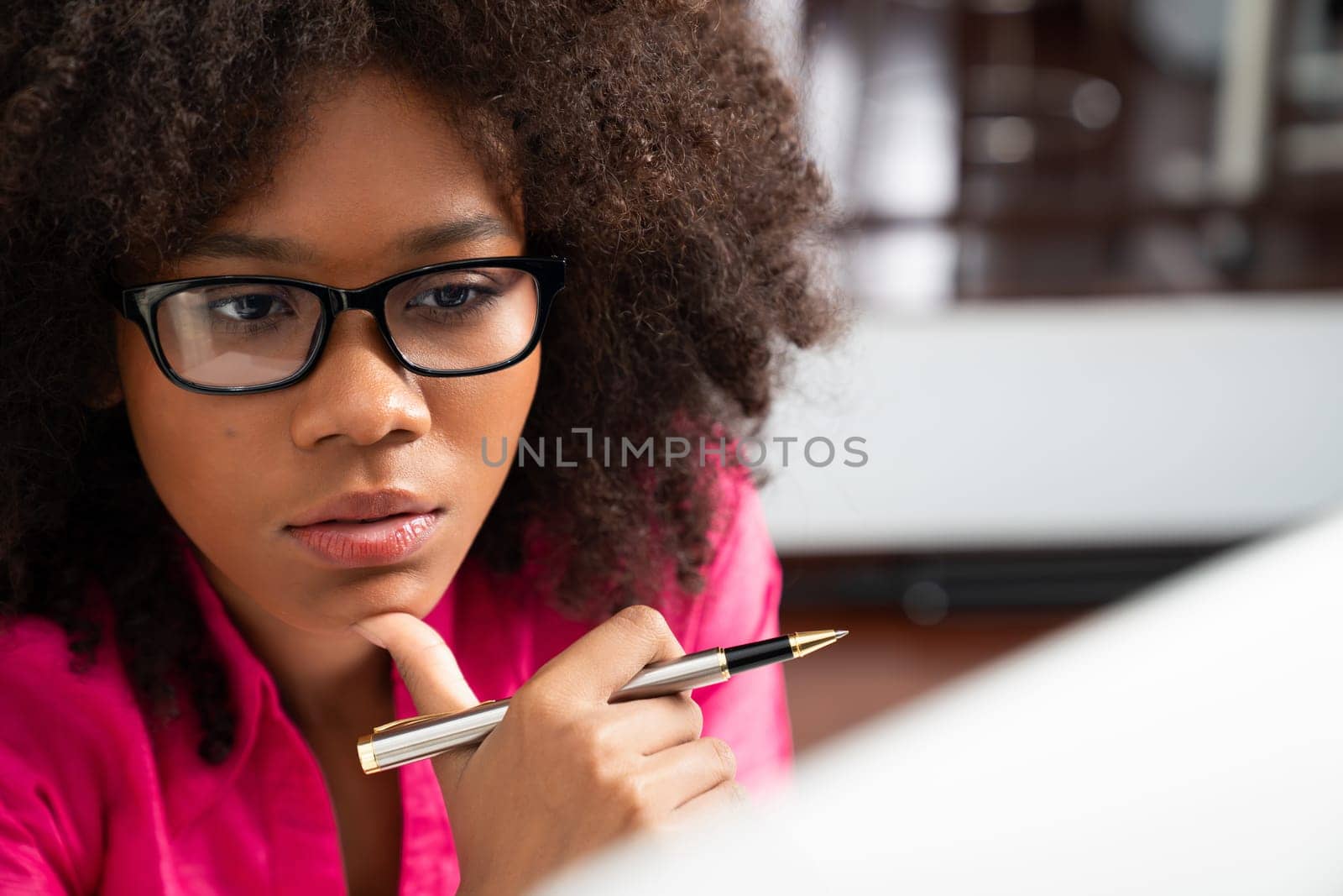 Portrait of young African woman creating website developer, thinking data information designer at home office, focusing on laptop. Concept of analytical data center in java project job. Tastemaker.