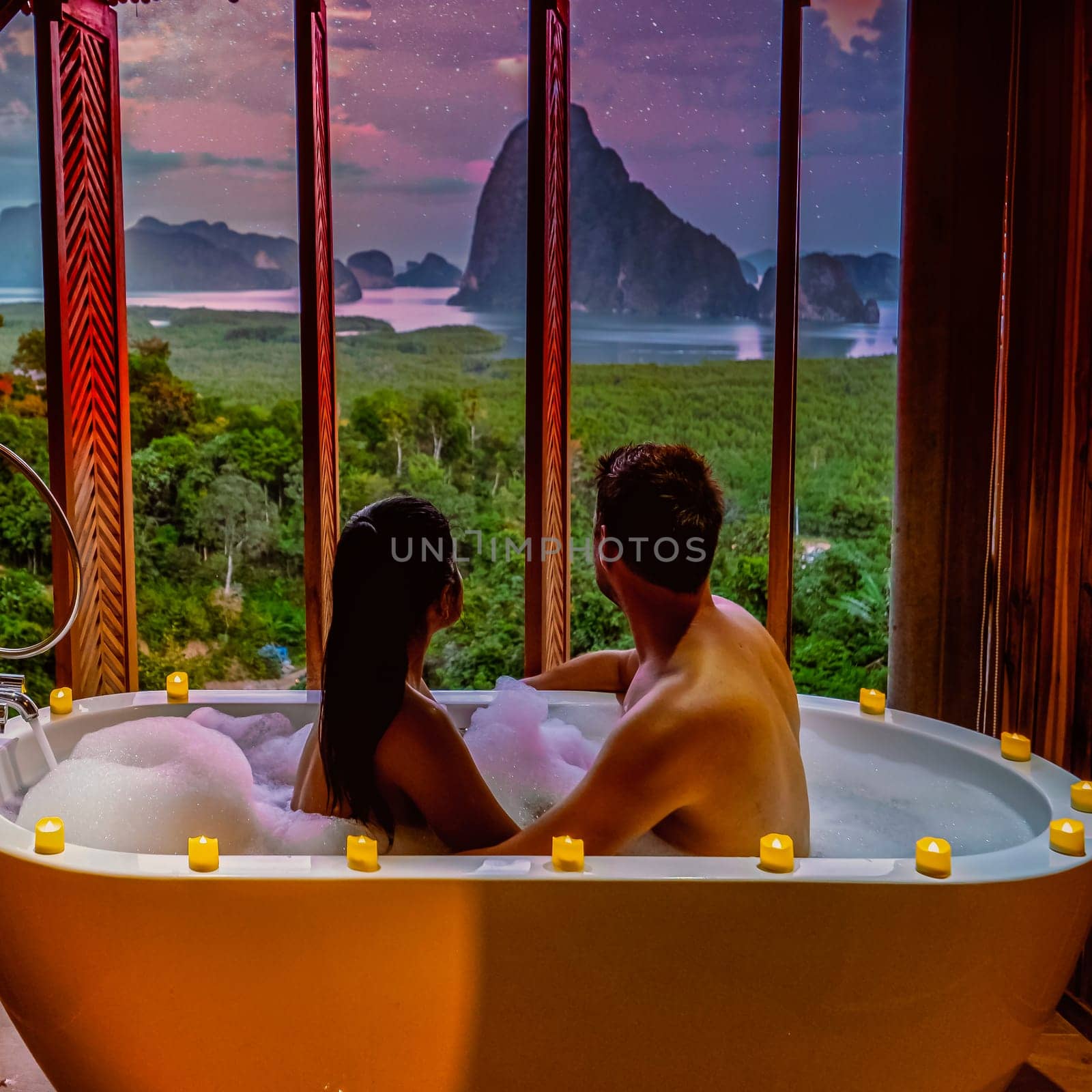 Phangnga Bay, Samet Nang She viewpoint sunset over the bay, couple honeymoon vacation Thailand watching the sunrise, couple men and women in the bathtub watching the sunset from their room