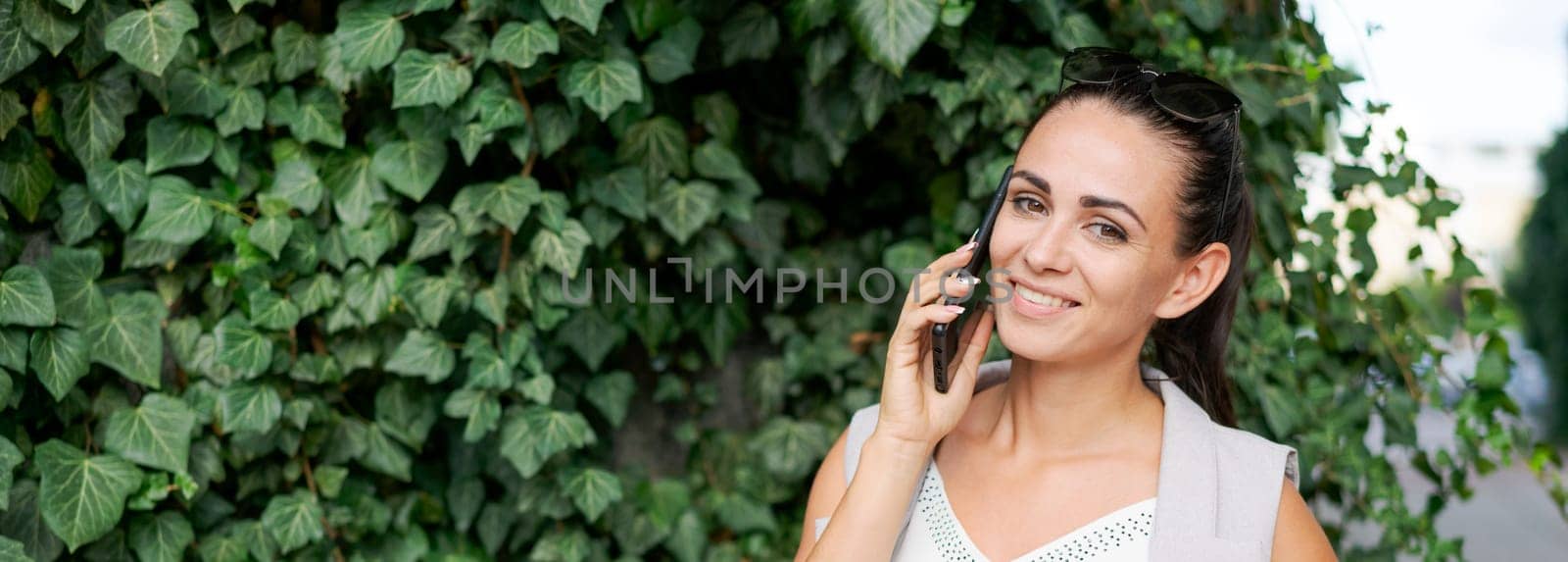 Attractive brunette businesswoman talking on mobile phone. Caucasian business by EkaterinaPereslavtseva