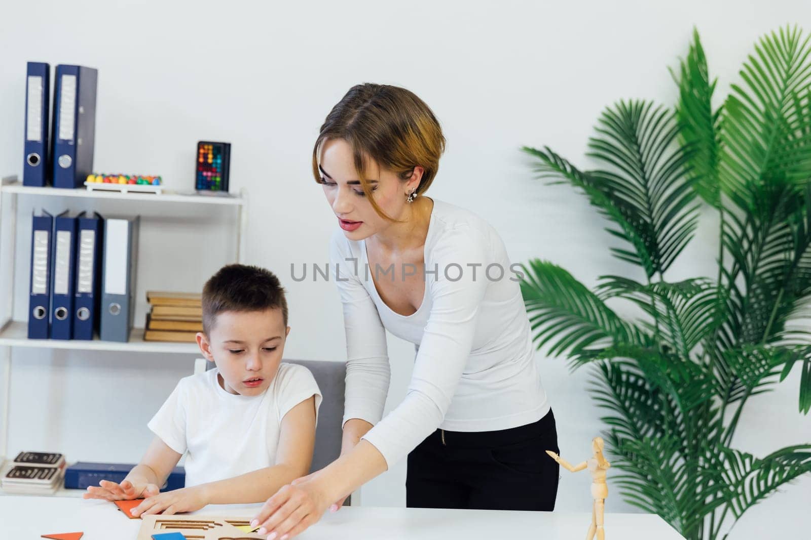 Woman playing with boy in educational educational games