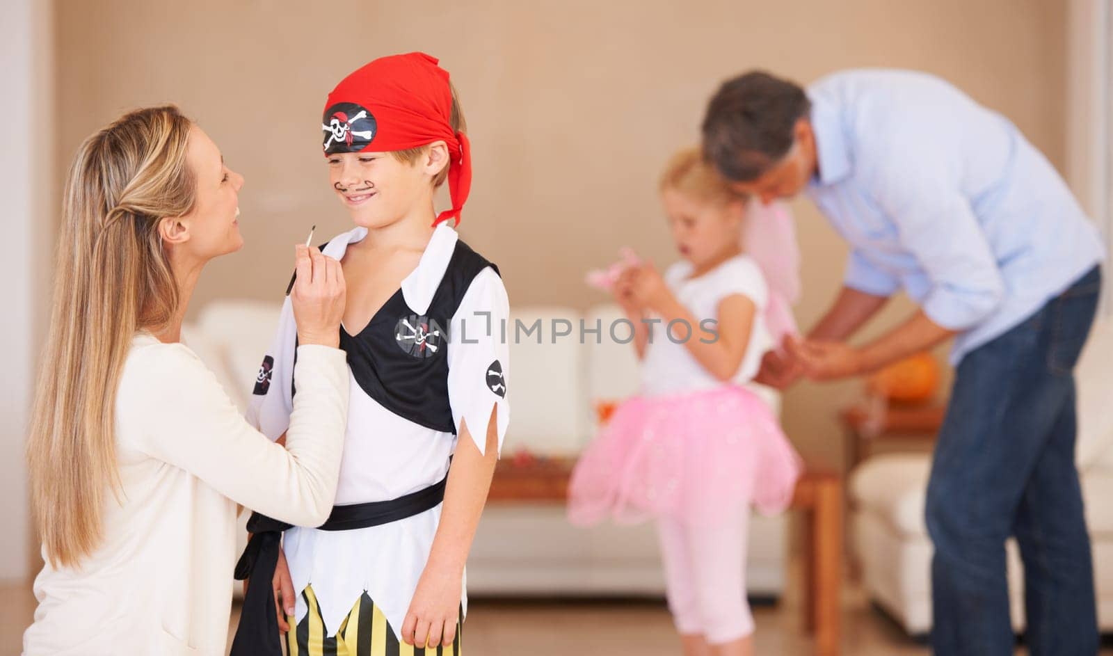 Boy, pirate costume and halloween with mother in home, face paint and happiness in childhood. Son, smile and house birthday with party clothes by woman, love family and celebration together with care.
