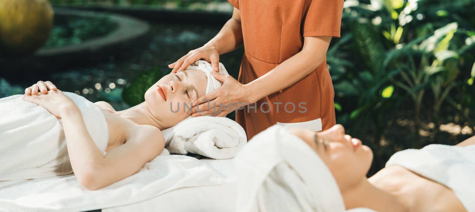 Two caucasian woman having facial massage surrounded by nature. Tranquility. by biancoblue