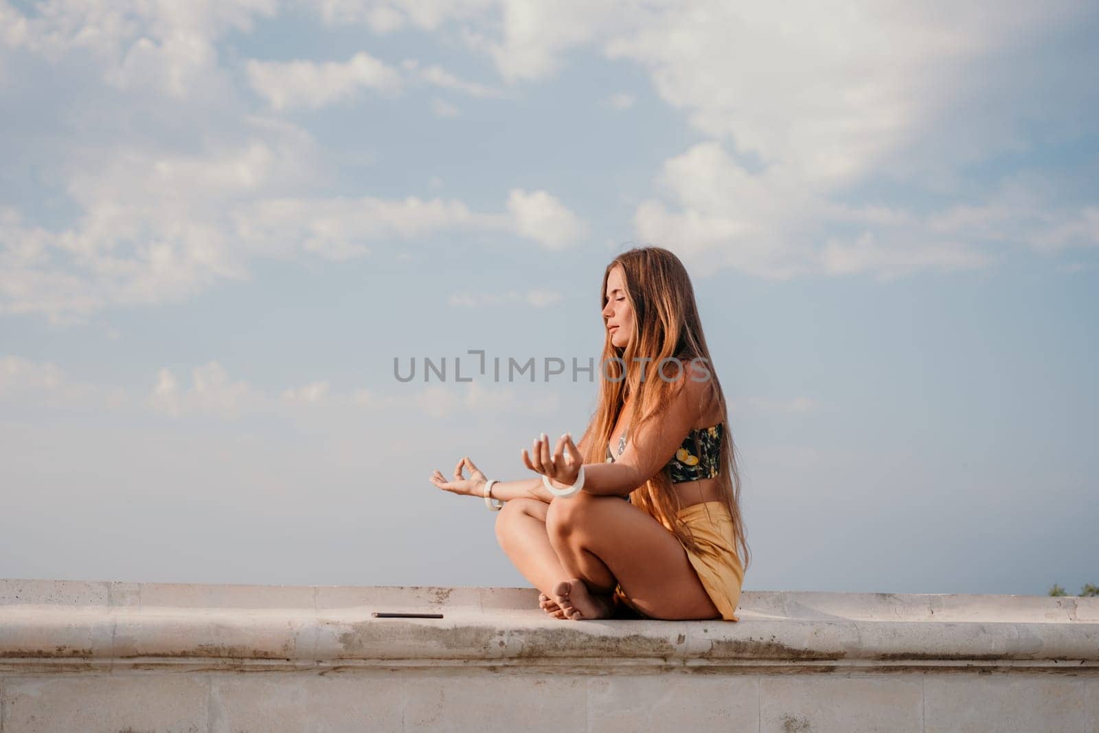 Woman park yoga. Side view of free calm bliss satisfied woman with long hair standing in morning park with yoga position against of sky by the sea. Healthy lifestyle outdoors in park, fitness concept. by panophotograph