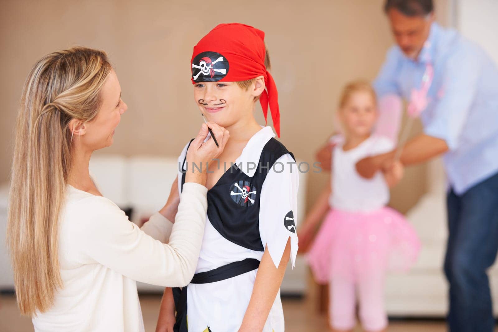 Son, pirate costume and halloween with mother in home, face paint and happiness in childhood. Boy, smile and house birthday with party clothes by woman, love family and celebration together with care by YuriArcurs
