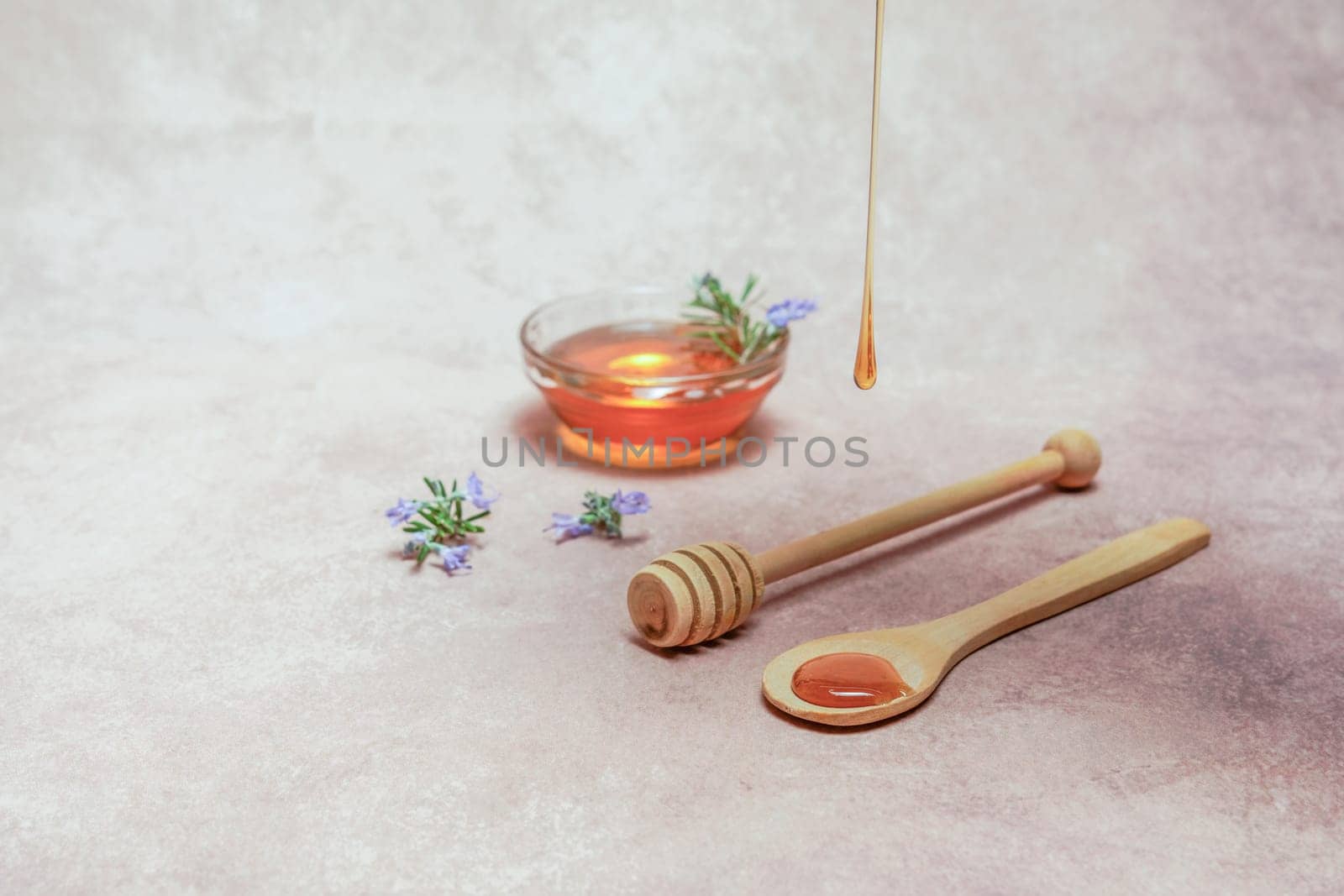 honey dripping on a wooden spoon by joseantona