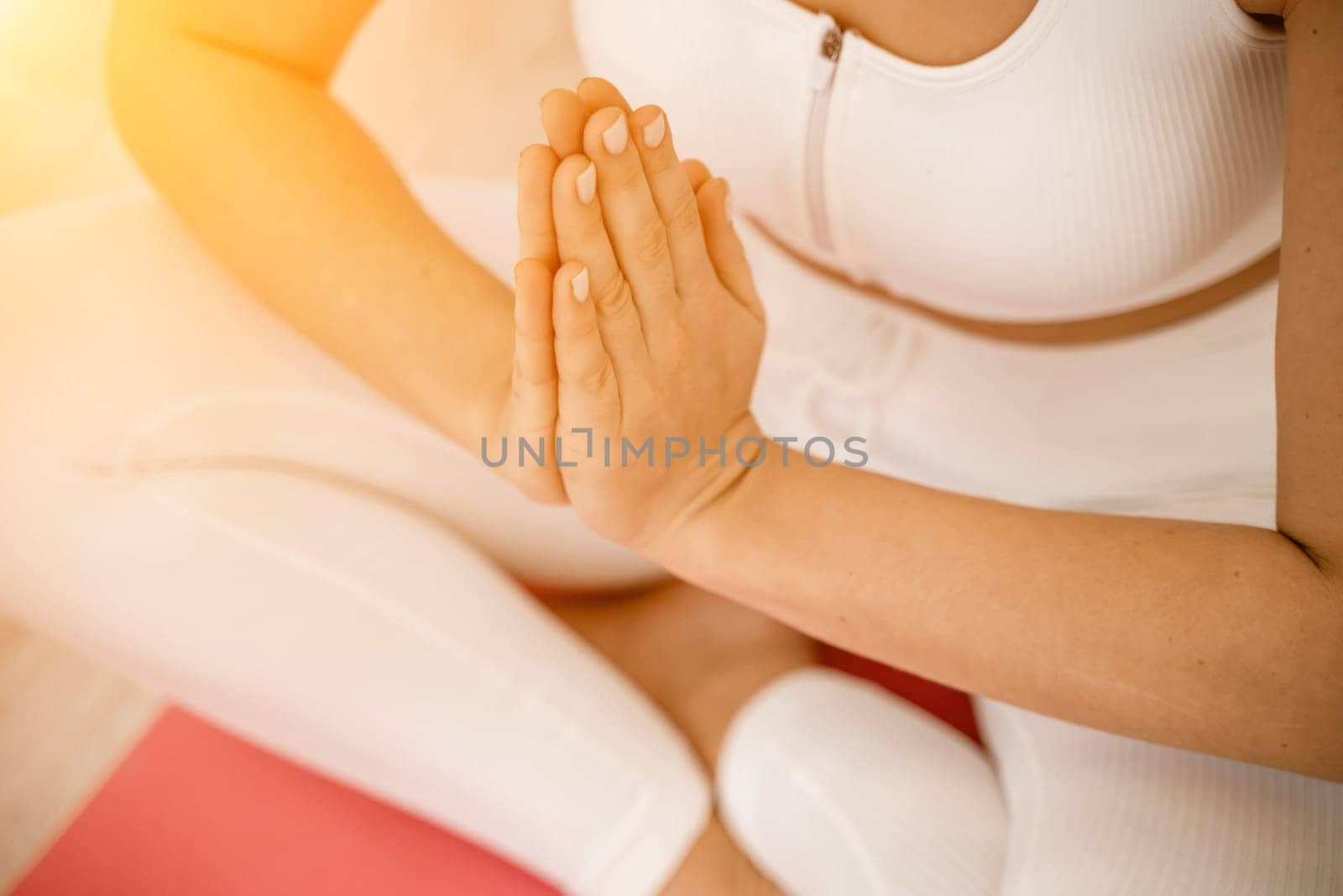 Girl does yoga. Young woman practices asanas on a beige one-ton background. by Matiunina