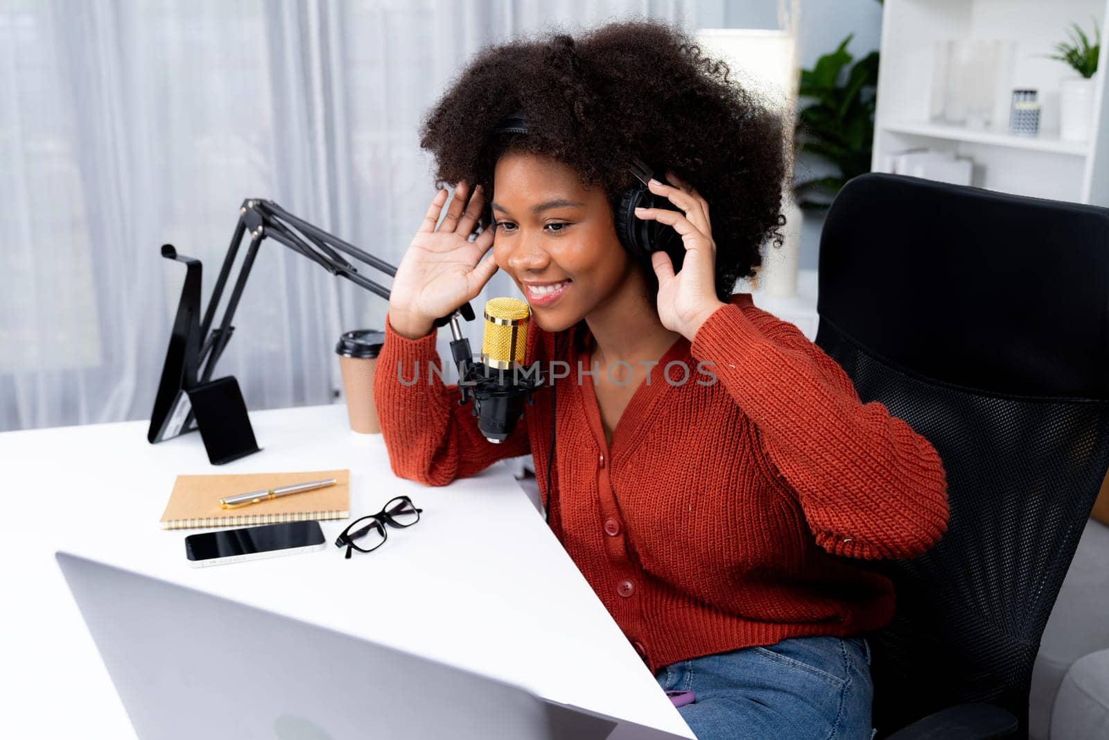 Host channel of beautiful African woman influencer talking with new listeners in broadcast studio. Time slot of life coach consultant on live social media online. Concept of giving advice. Tastemaker.