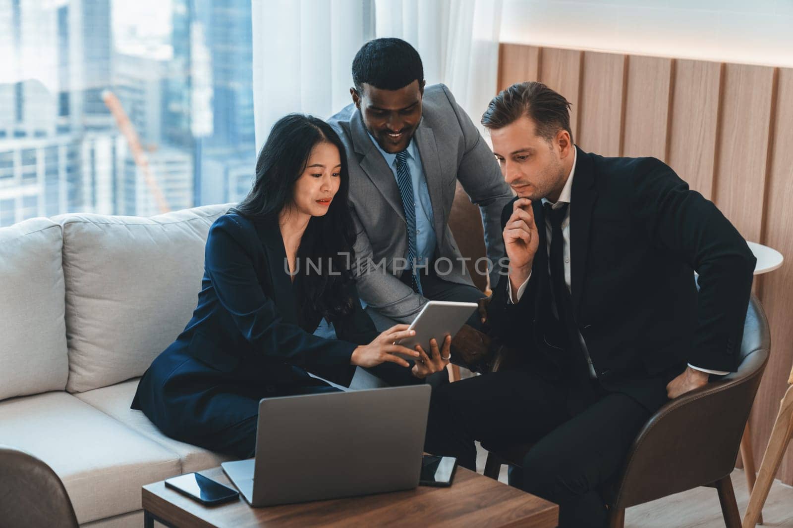 Group of skilled multiethnic businesspeople looking at data analysis by using tablet. Group of smart manager sharing, brainstorming, discussing, thinking about marketing strategy, idea. Ornamented
