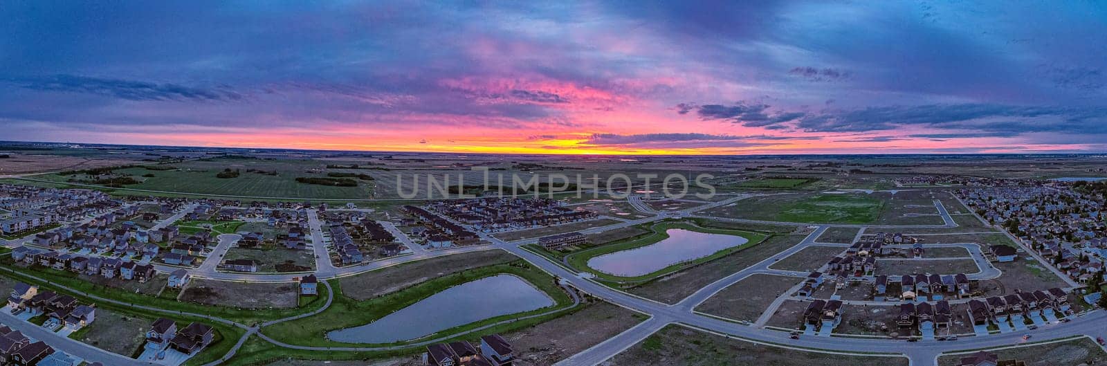 Discover Kensington in Saskatoon from a bird's-eye view. This drone image highlights the neighborhood's modern architecture, green spaces, and the lively, community-focused atmosphere.