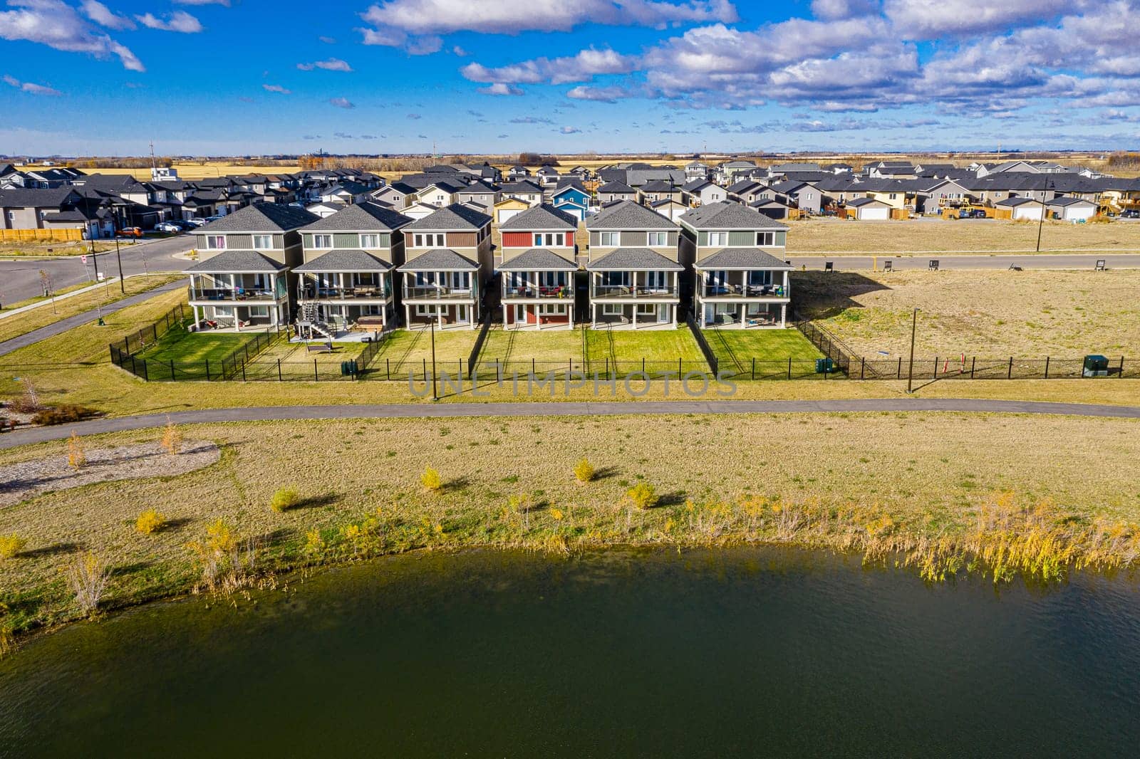 Discover Kensington in Saskatoon from a bird's-eye view. This drone image highlights the neighborhood's modern architecture, green spaces, and the lively, community-focused atmosphere.