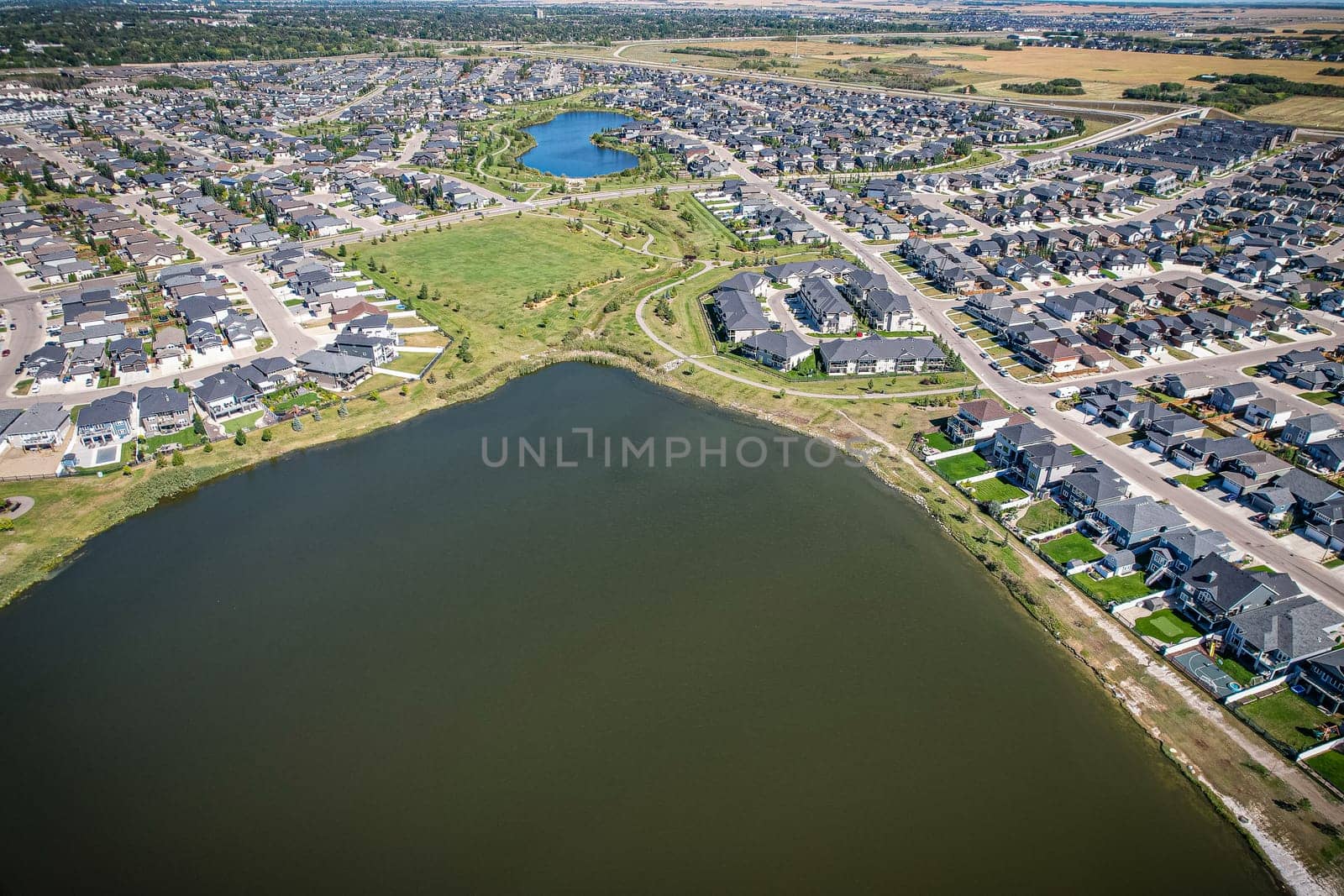 Captivating aerial shot of Stonebridge in Saskatoon, highlighting the harmonious blend of modern architecture and Saskatchewan's verdant surroundings.