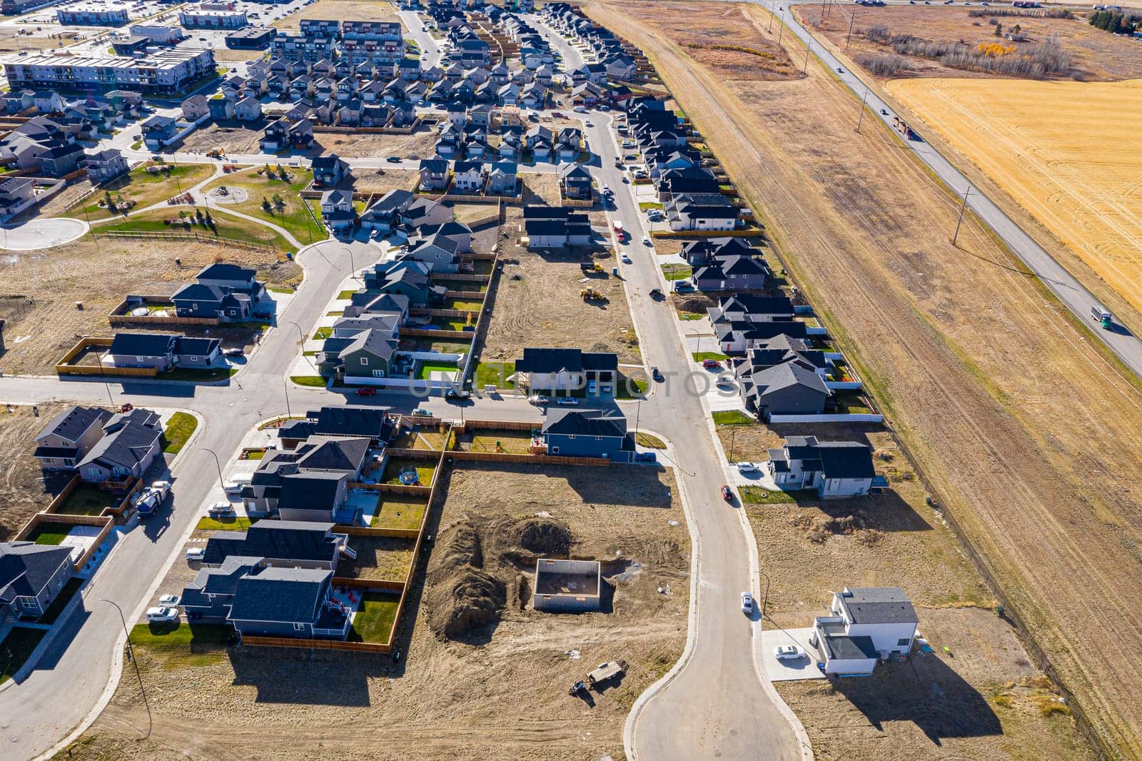 Discover Kensington in Saskatoon from a bird's-eye view. This drone image highlights the neighborhood's modern architecture, green spaces, and the lively, community-focused atmosphere.