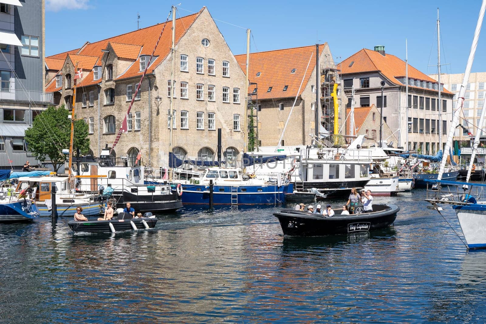 Copenhagen, Denmark - July 12, 2022: A canal and boats in Christianshavn district in the historic city centre.