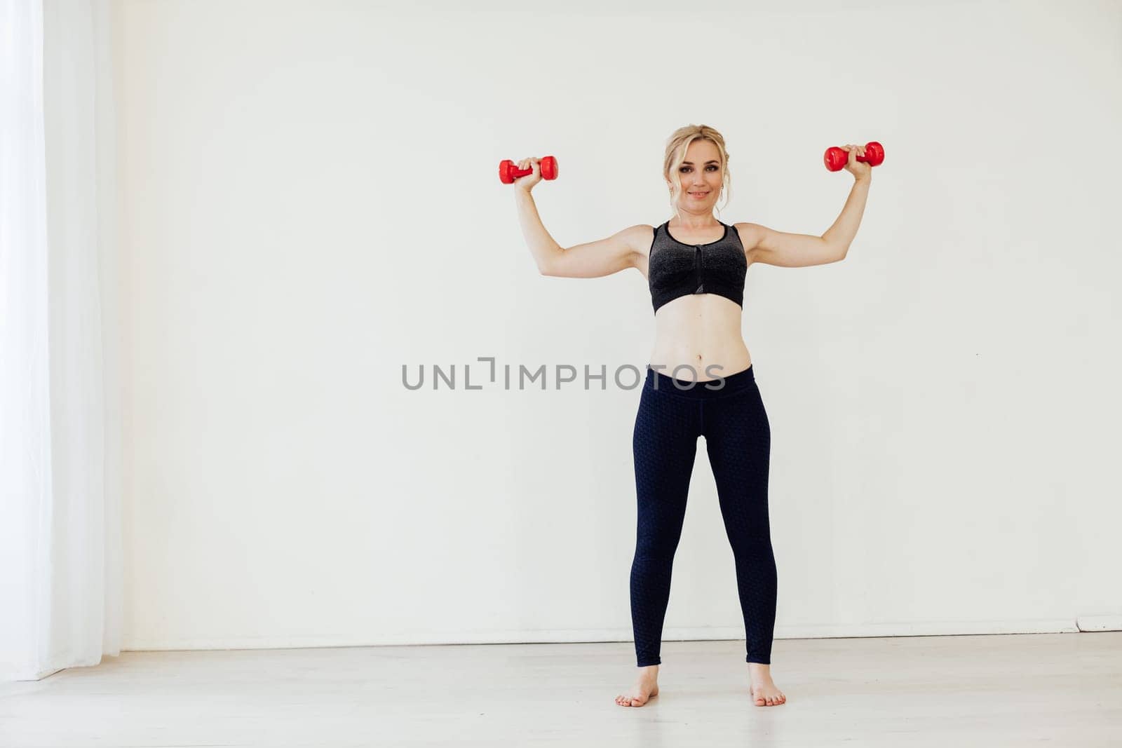 Female engaged in fitness with dumbbells sport