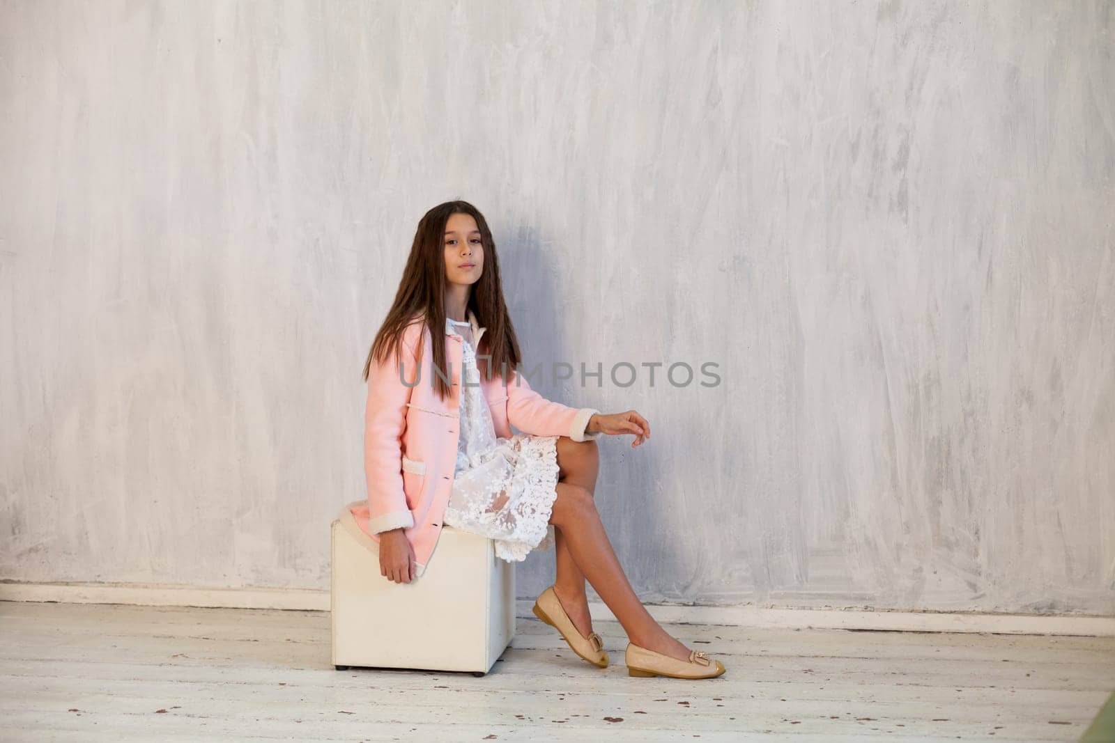 Portrait of a beautiful brunette girl in pink clothes by Simakov