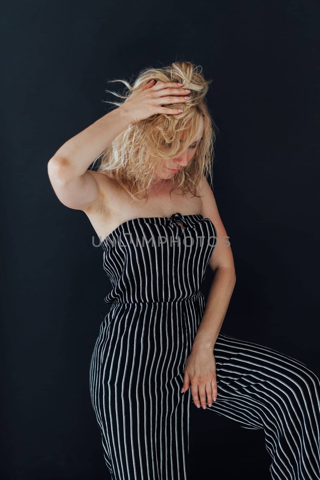 Portrait of a blonde woman in black striped pajamas