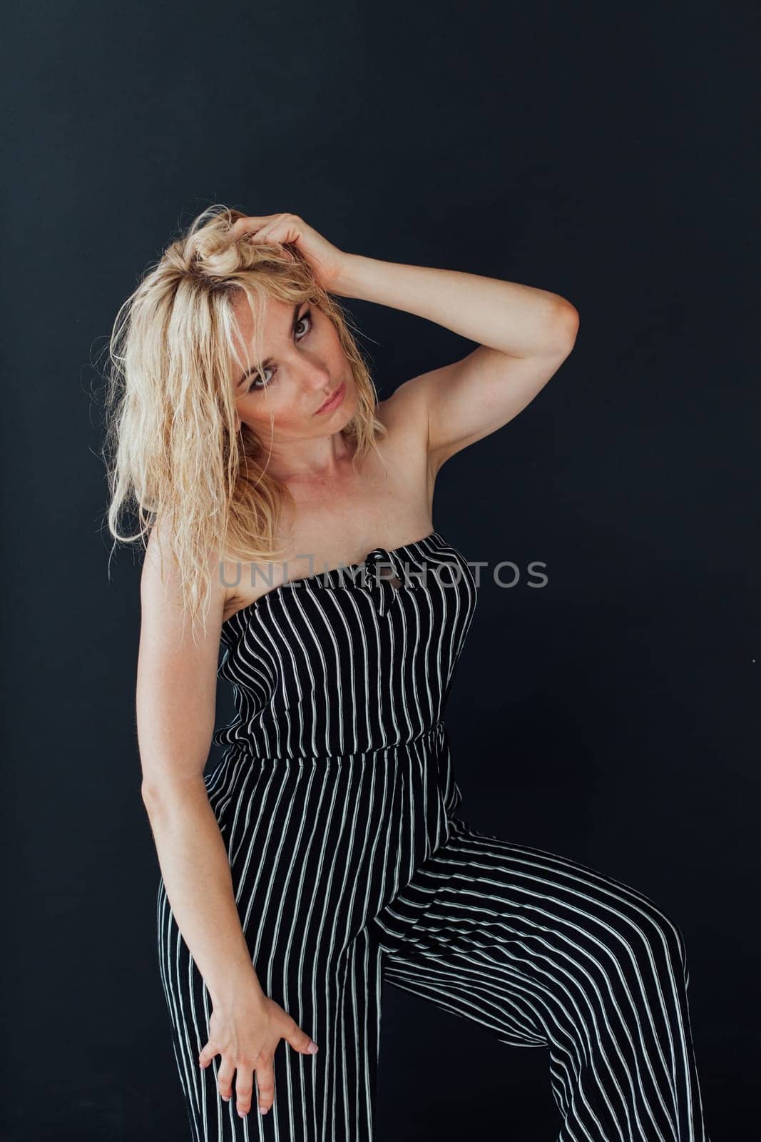 Portrait of a blonde woman in black striped pajamas