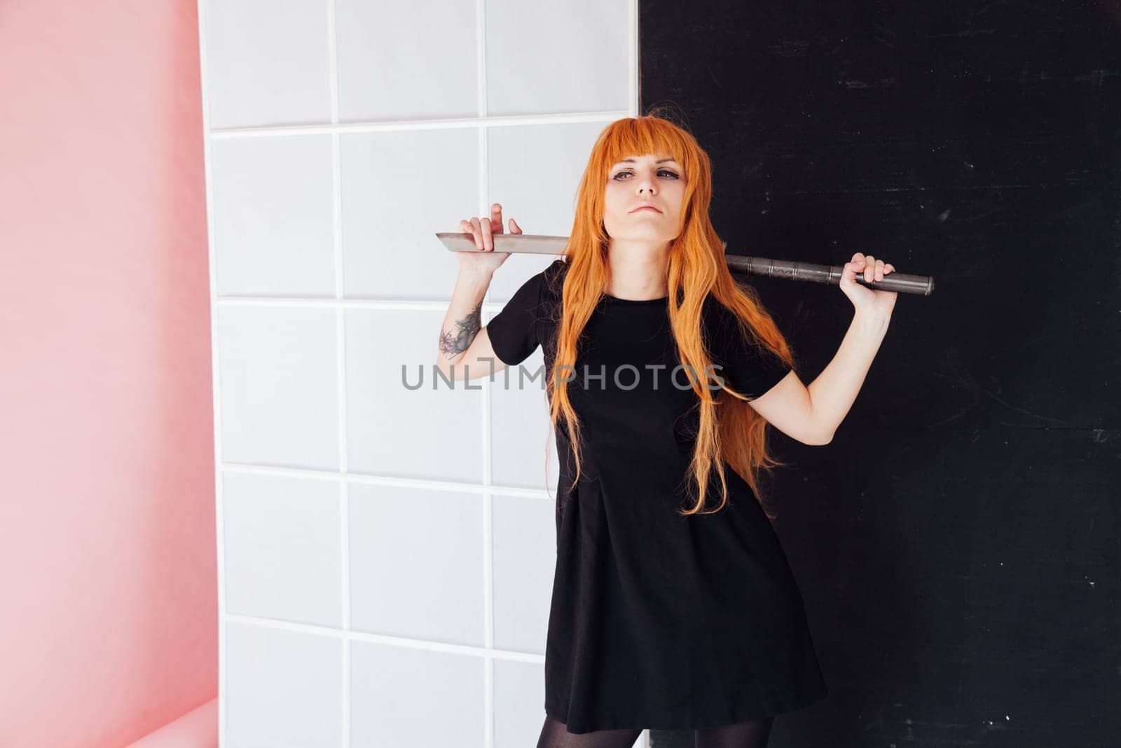 Woman cosplayer anime with red hair holds a Japanese sword by Simakov