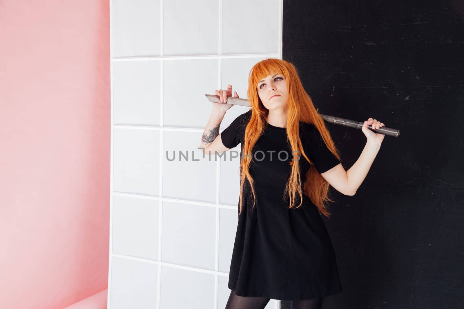 Woman cosplayer anime with red hair holds a Japanese sword by Simakov