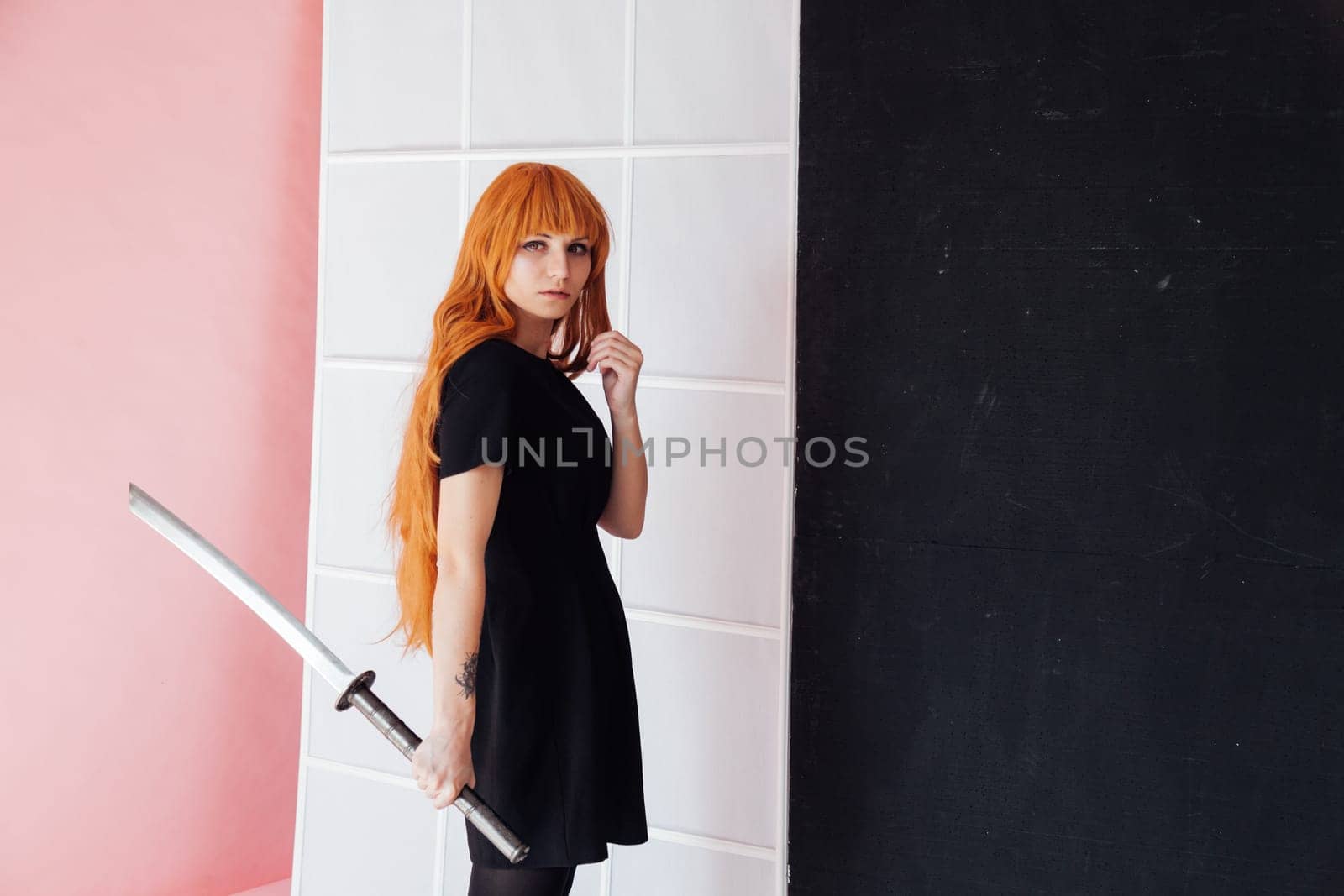 Woman cosplayer with red hair holds Japanese sword by Simakov