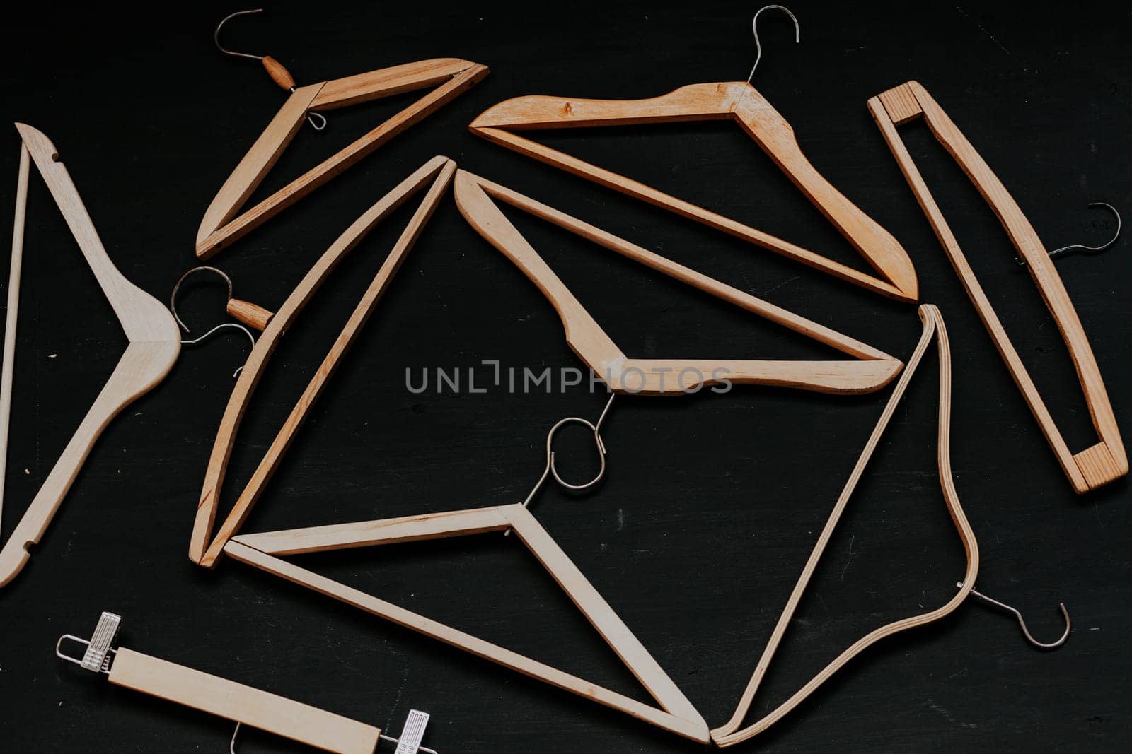 Vintage clothing hangers on a black background by Simakov