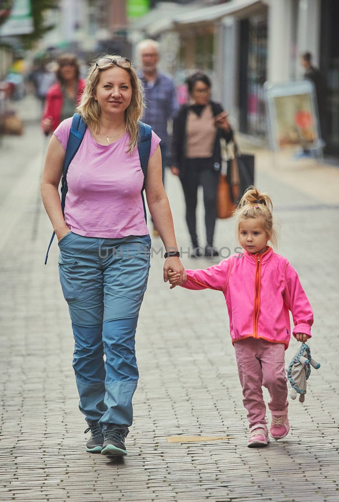 Mom and daughter walk around the city in the Netherlands.