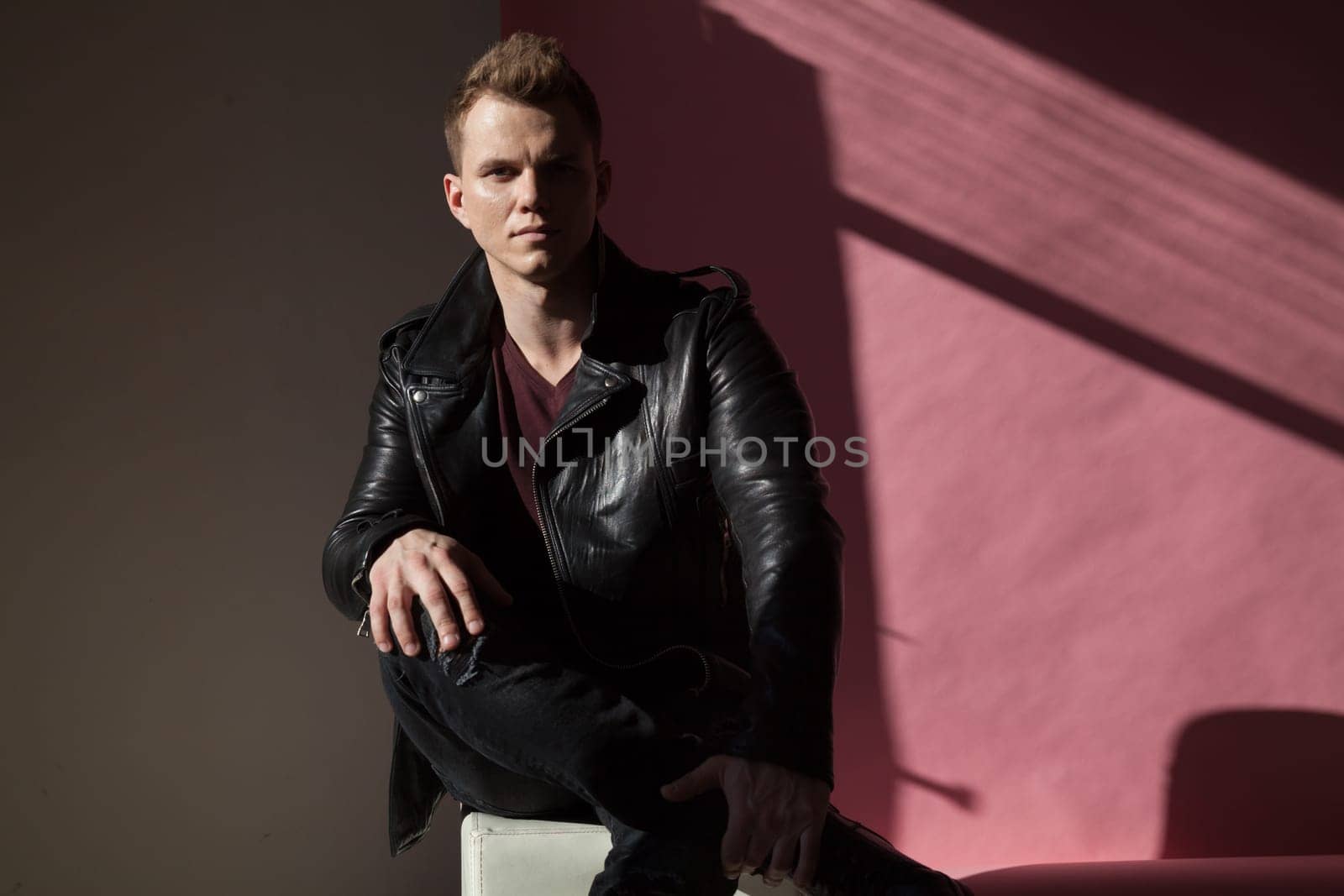 portrait of a young fashionable man in a leather jacket