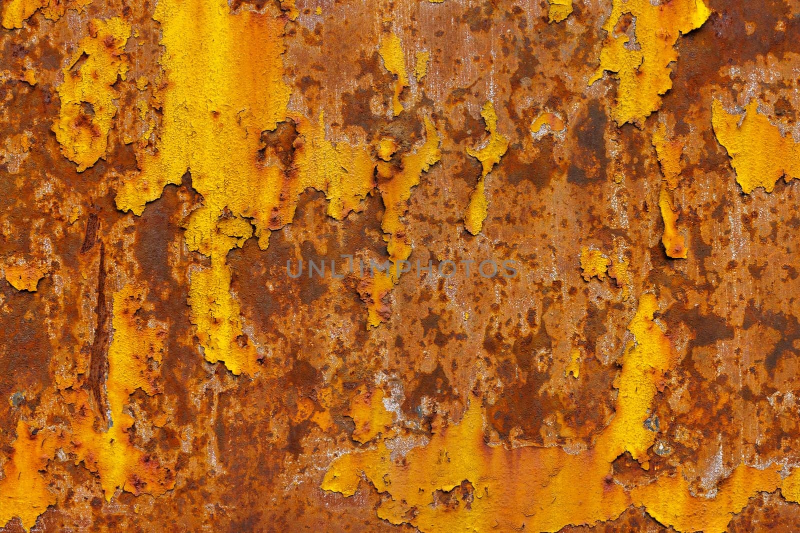 beautifully rusted thick sheet metal with leftovers of yellow paint texture and full-frame background by z1b