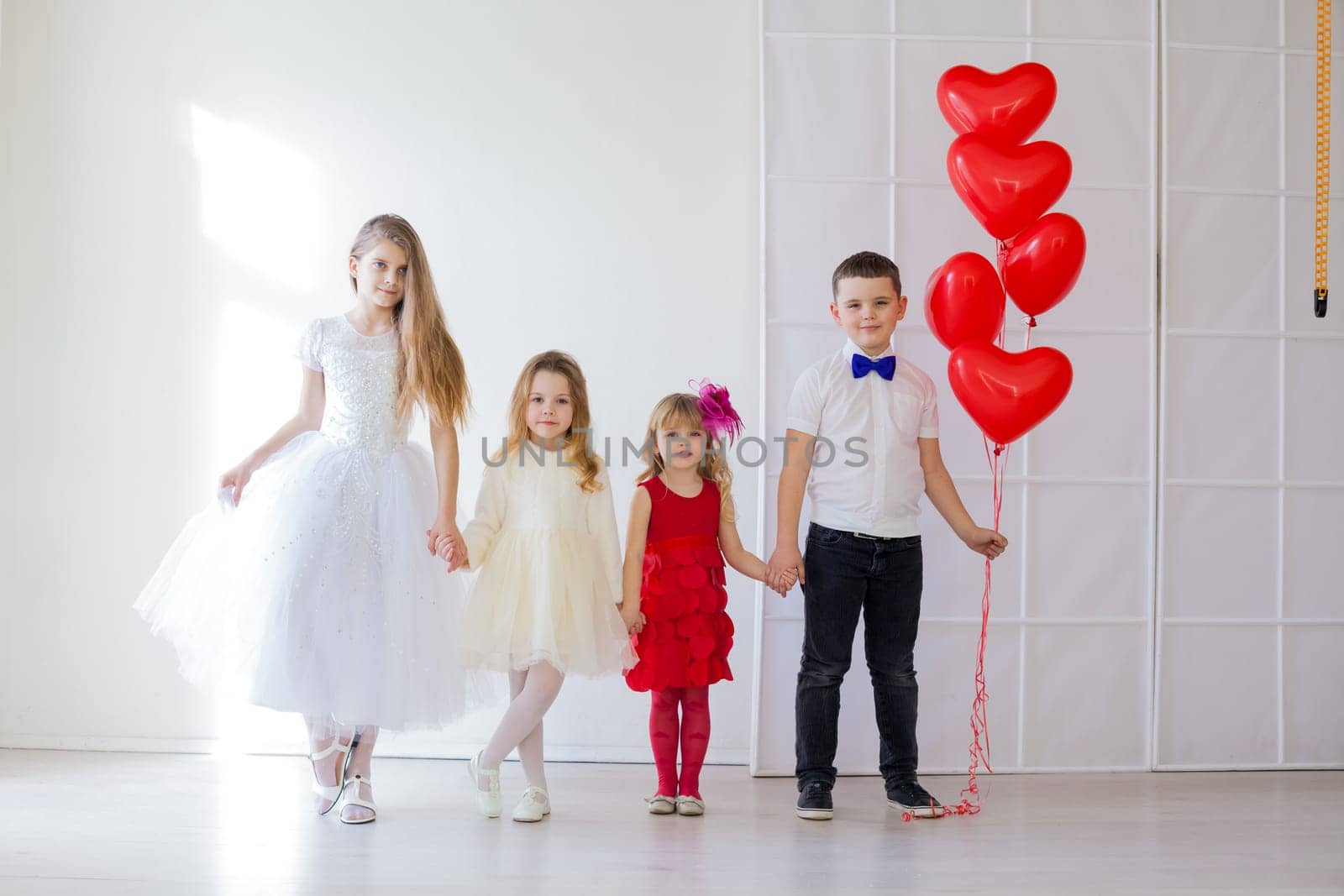 Boy and thre little girl brother and sisters with balloons by Simakov