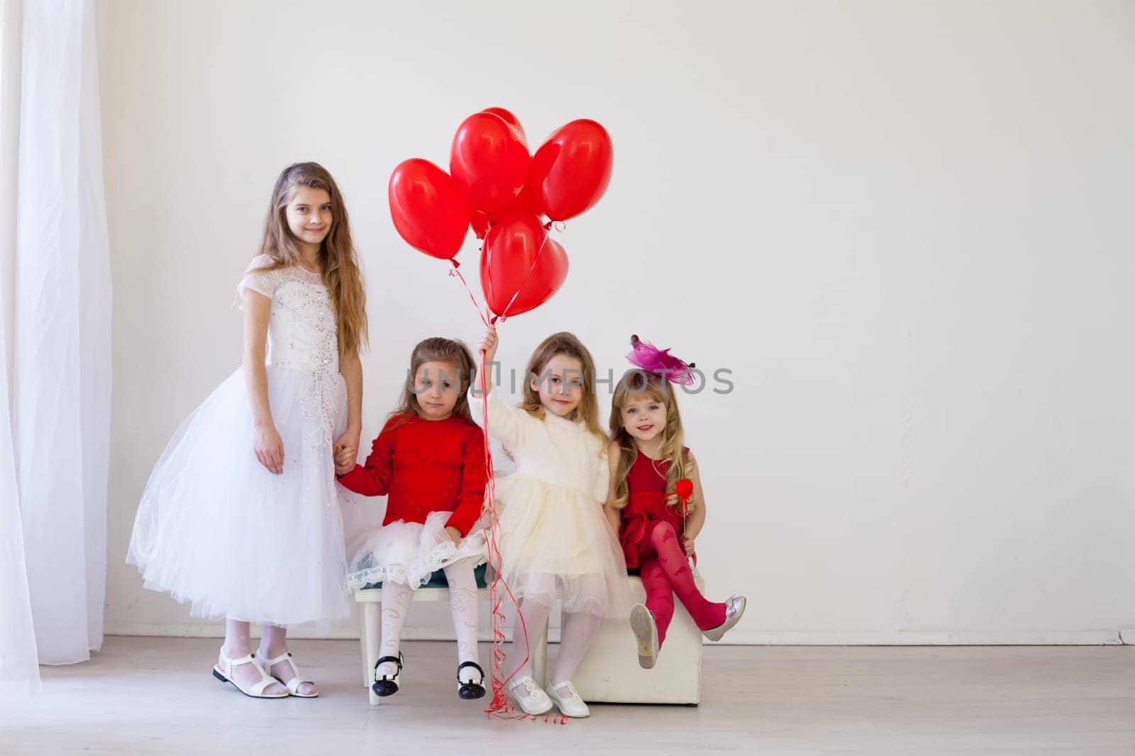 four girls in a white room with red balloons by Simakov