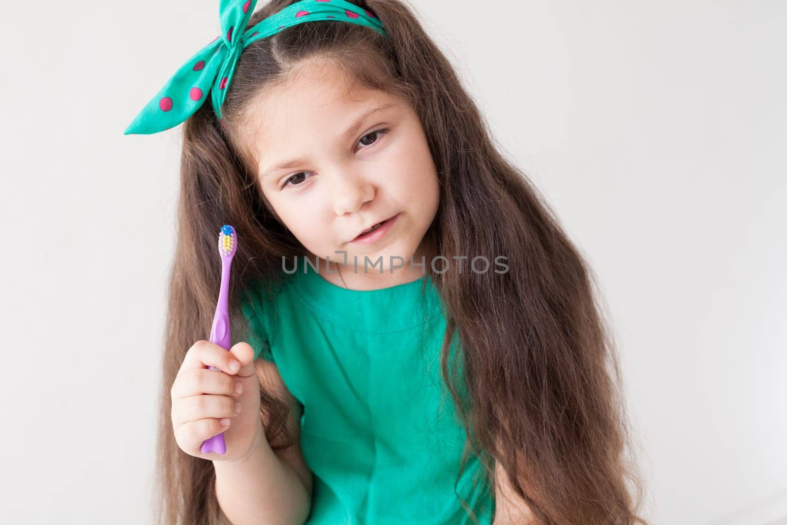 Beautiful little girl brushes her teeth with a toothbrush