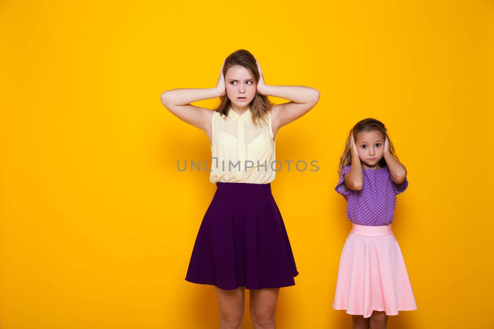 Two fashionable little sister girls of different ages by Simakov