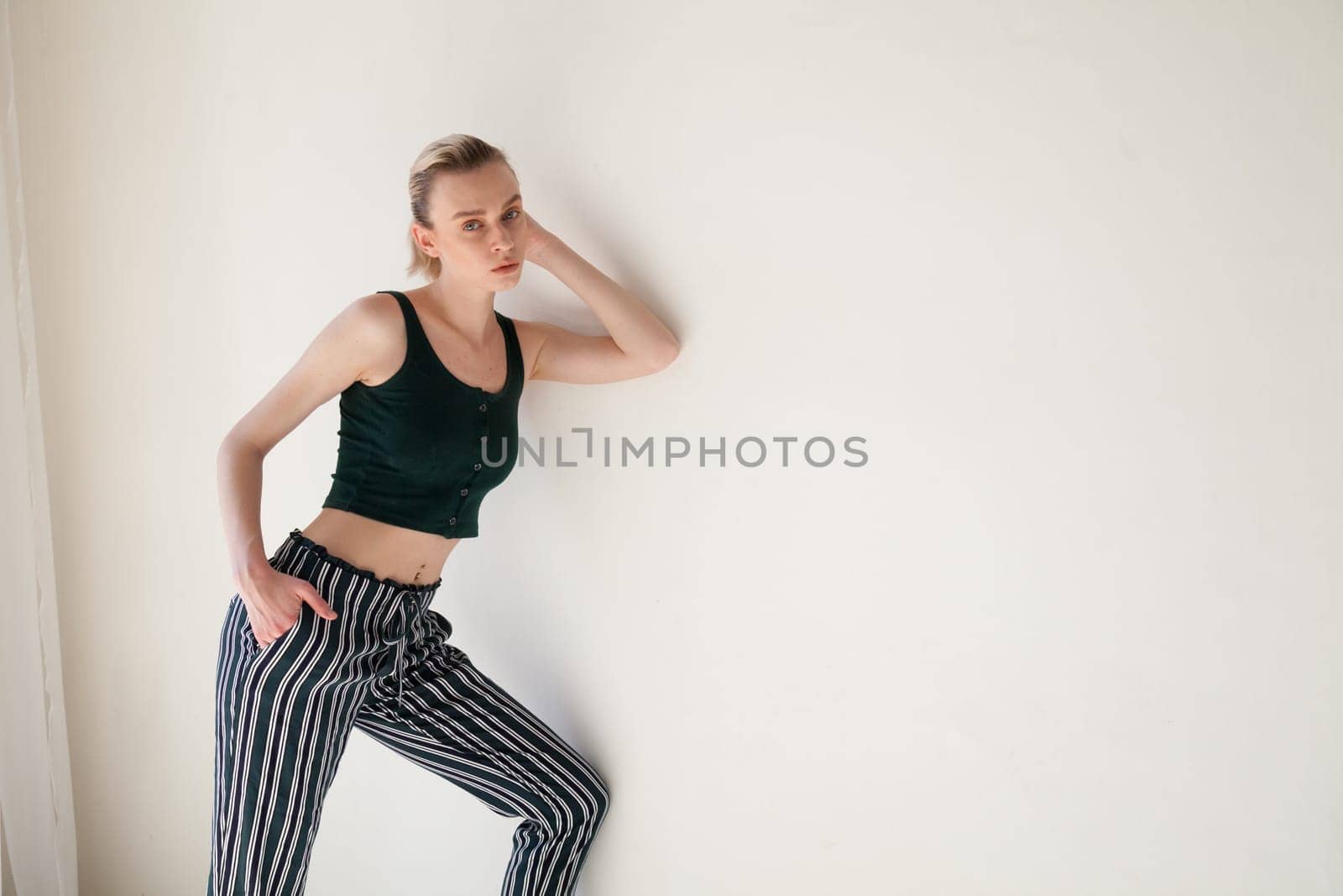 Portrait of a blonde woman in striped pants