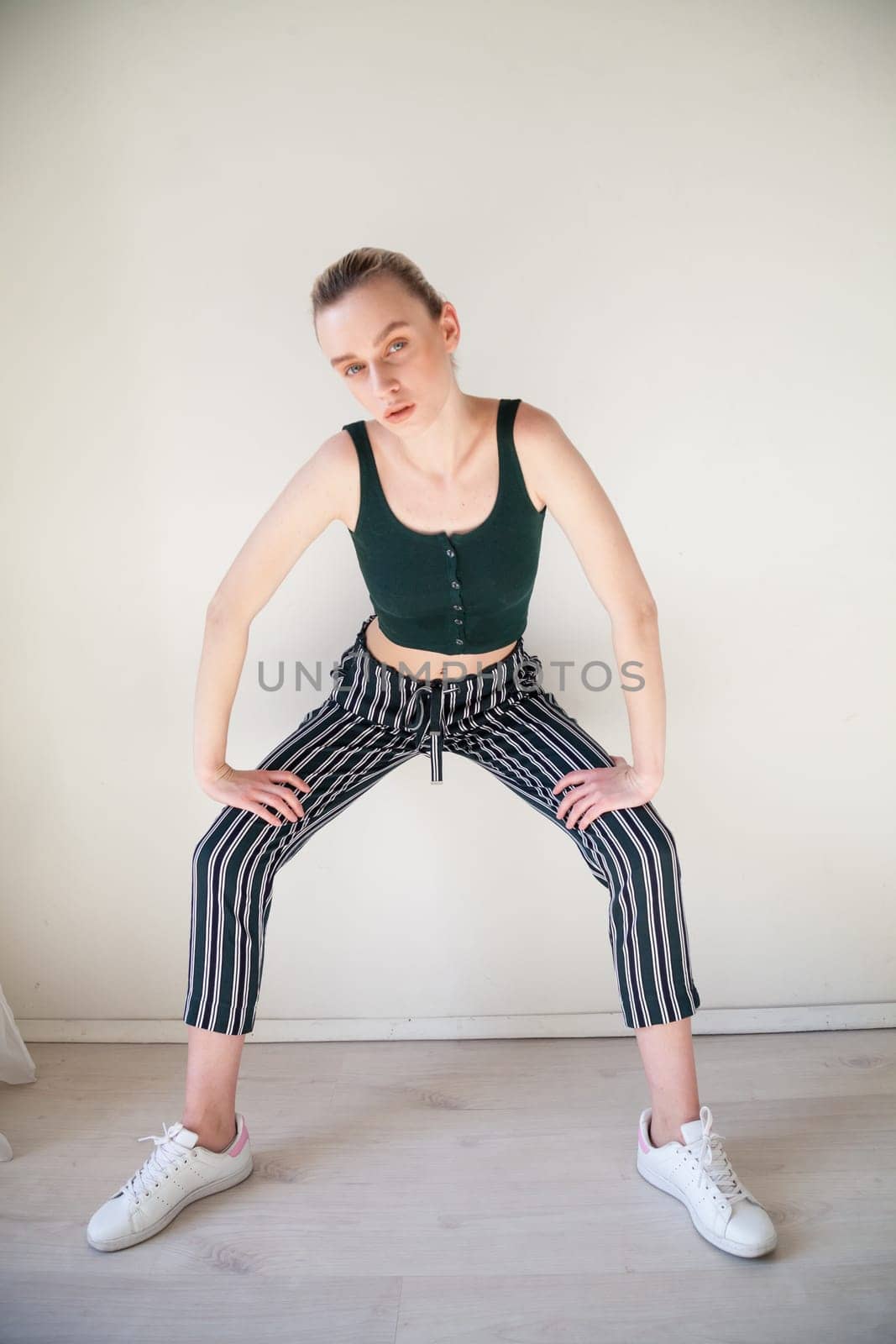 Portrait of a blonde woman in striped pants