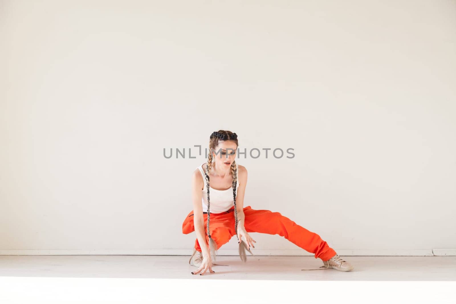 Portrait of a beautiful woman with braids dancing to music by Simakov