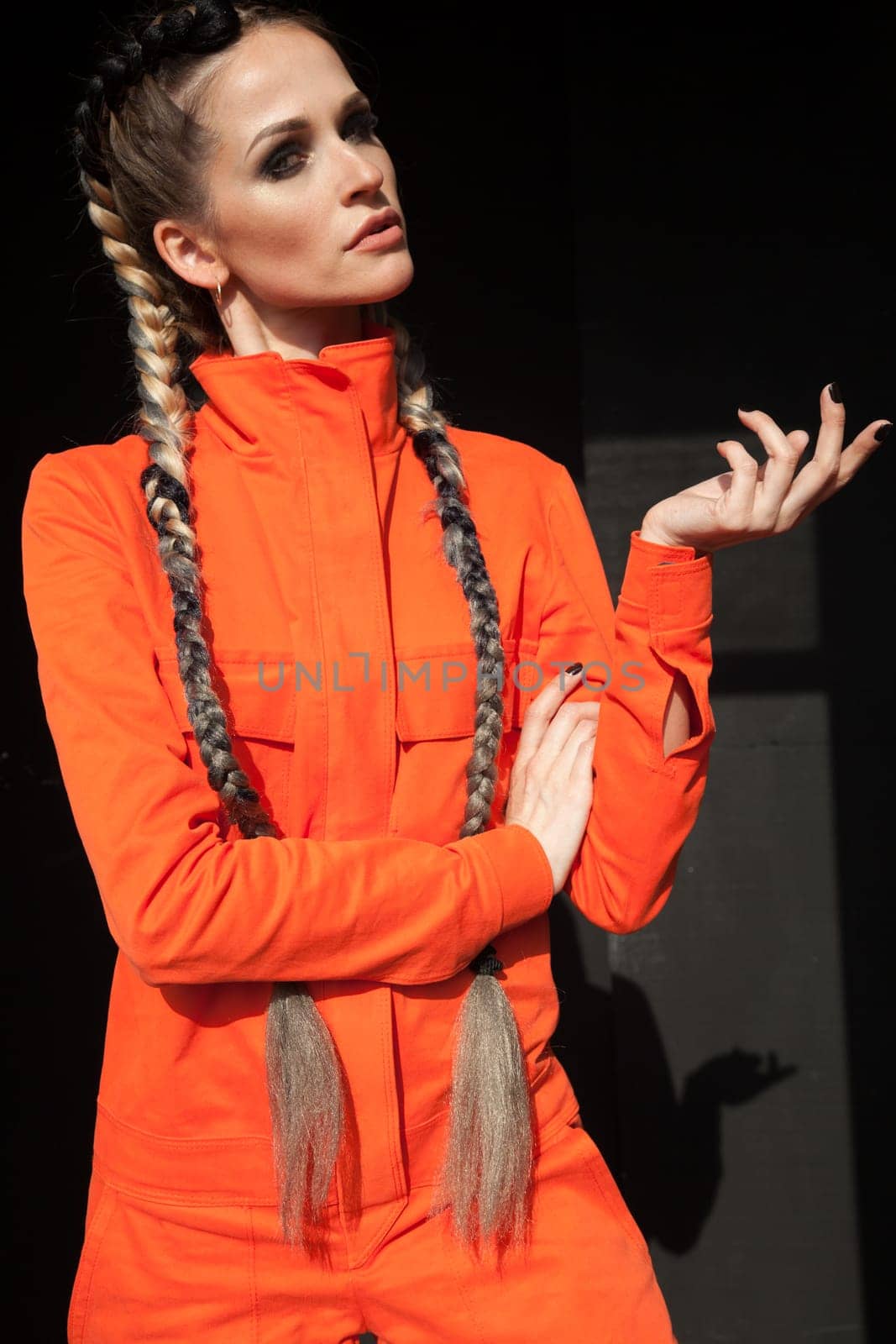 Portrait of a beautiful convex woman with braids s work orange clothes