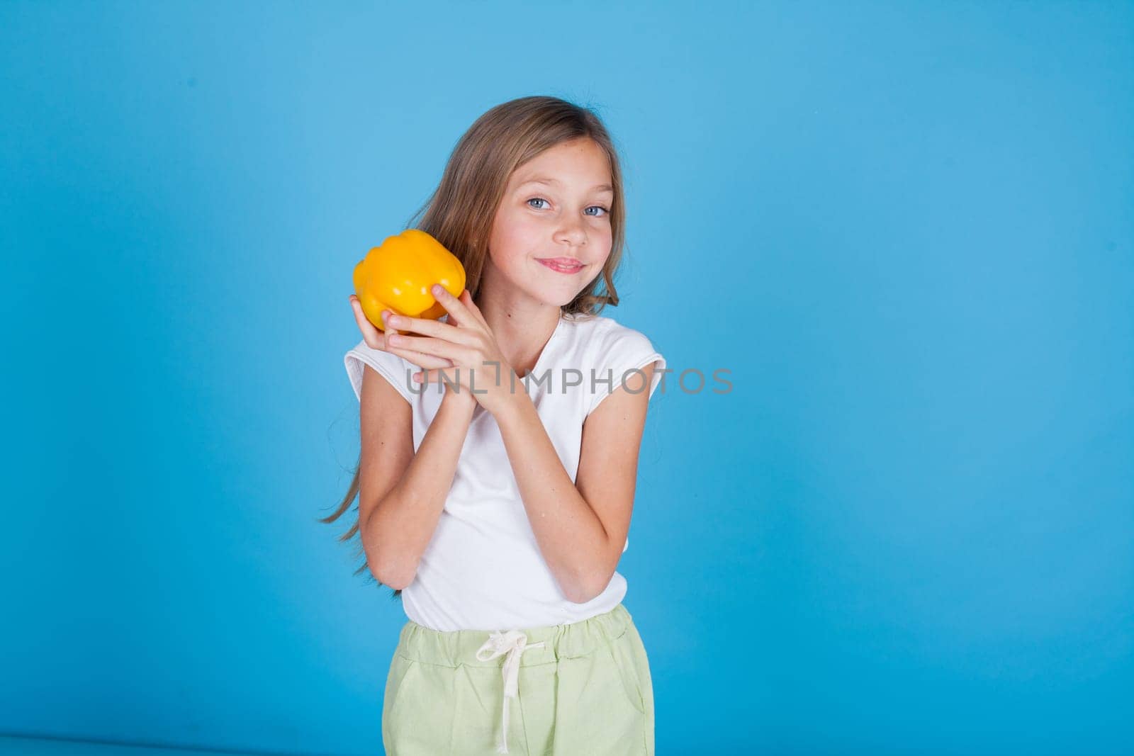 Beautiful little girl holding a ripe orange by Simakov