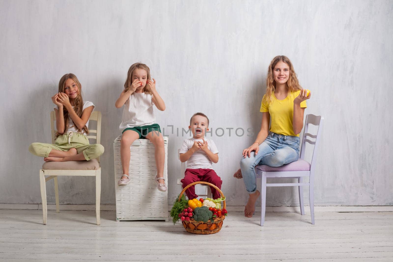 kids boy and girls with a basket of ripe vegetables and fruits by Simakov